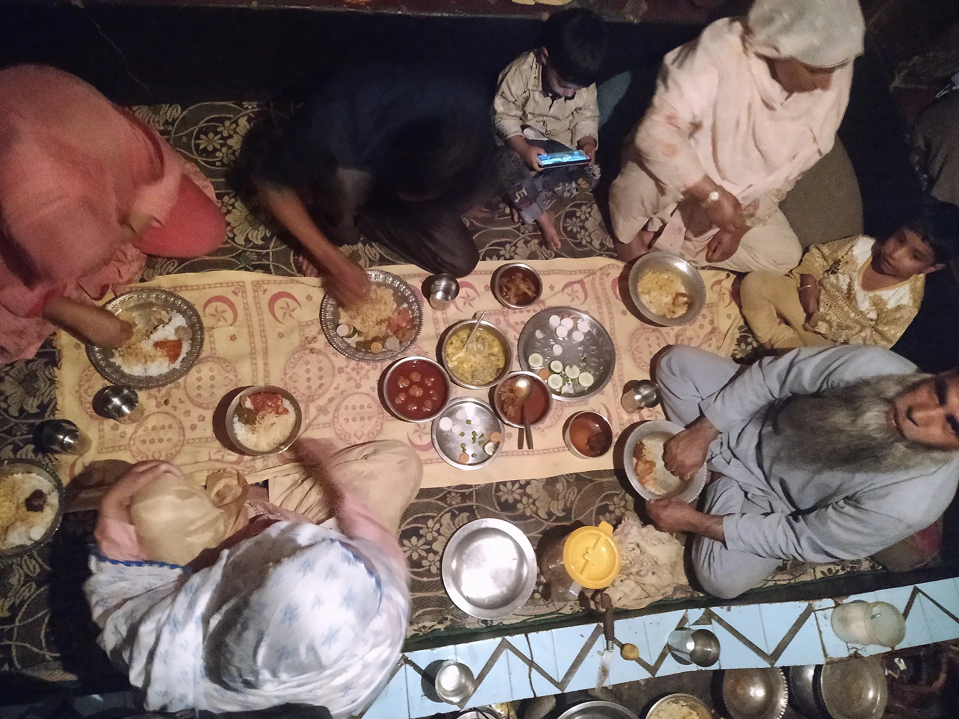 A Kashmiri family sharing a traditional meal