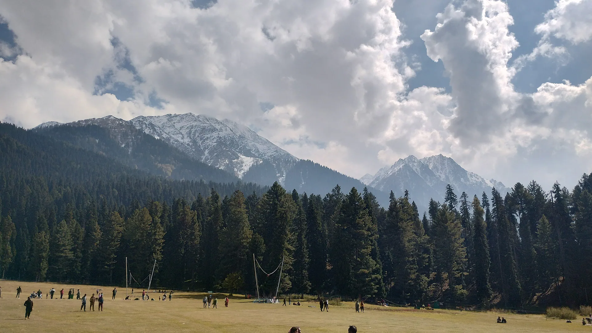 The meadow of Baisaran ringed by pine forest