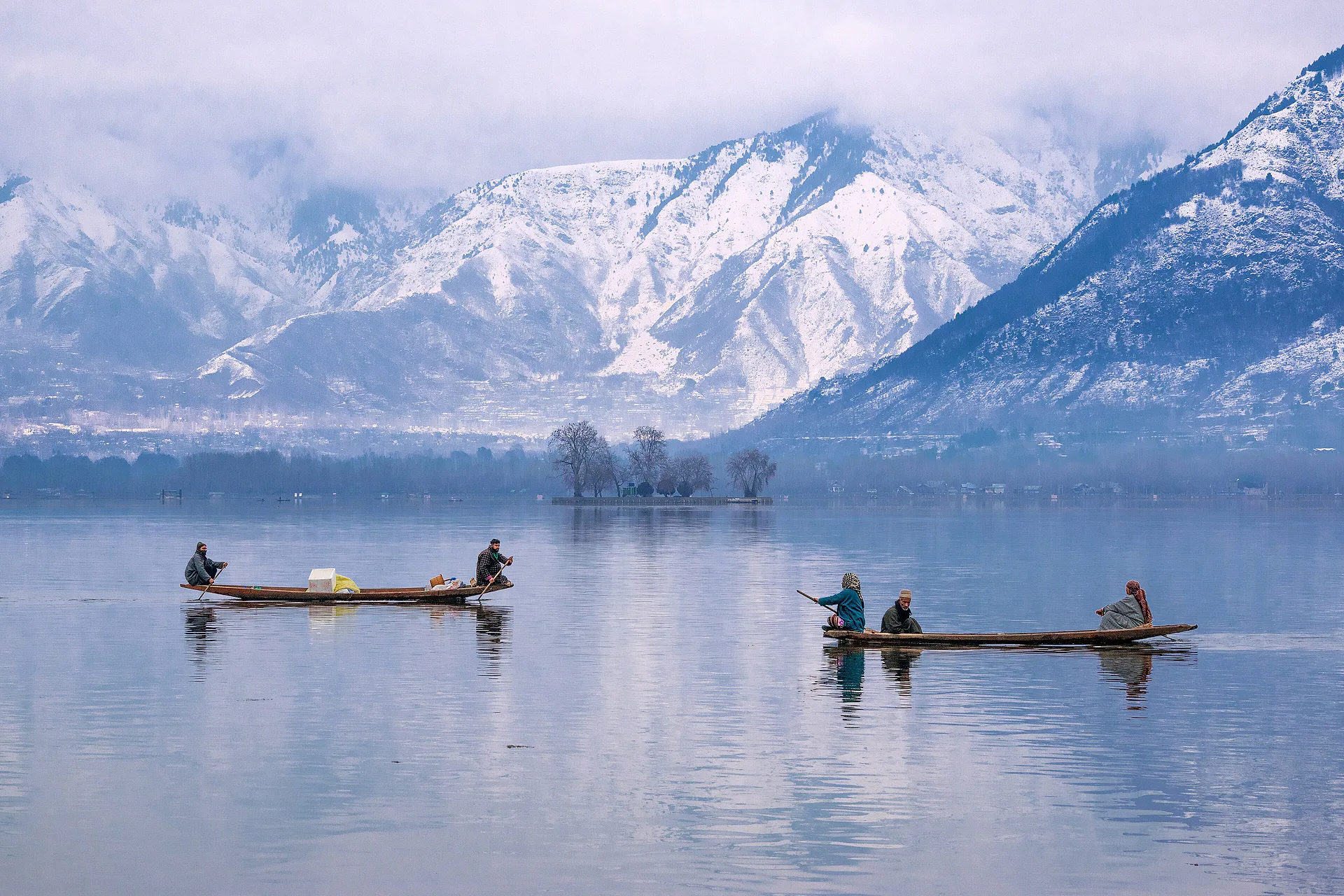 Shikaras crossing Dal Lake beneath snow-covered mountains, Srinagar
