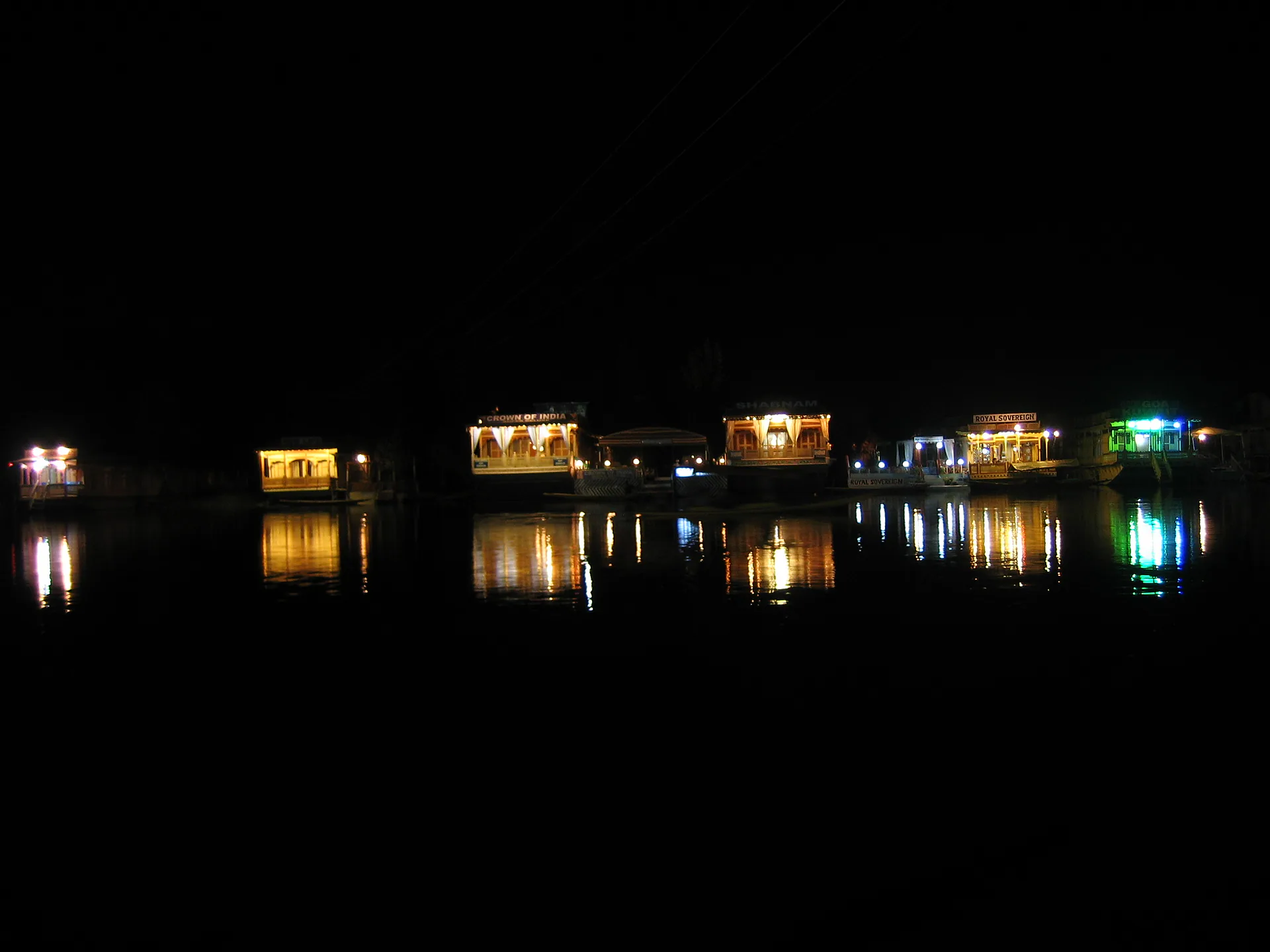 Houseboat lights reflected on Dal Lake at night