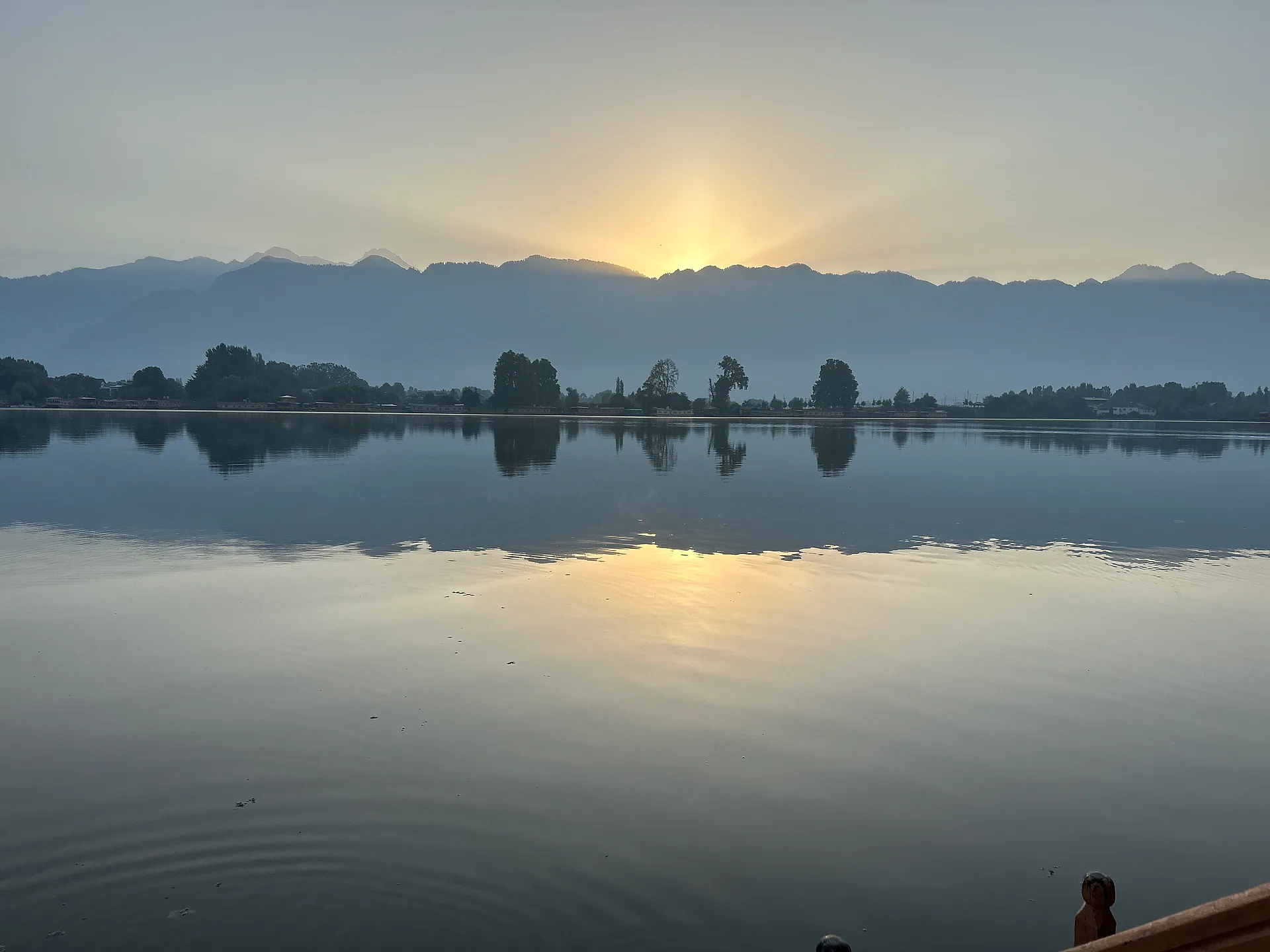 Sunrise over the mountains reflected in Nigeen Lake